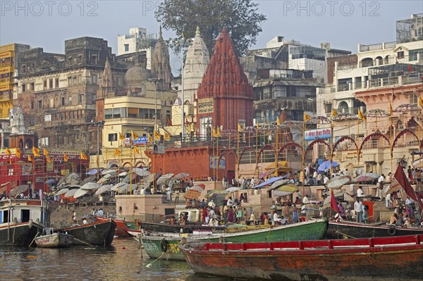 Holy city and colourful rowing boats on the Ganges river at Varanasi, Uttar Pradesh, India, Asia