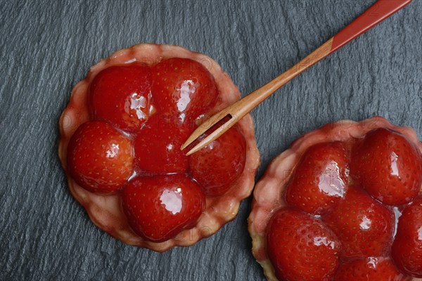 Topped strawberry tarts with a fork