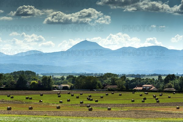 View of the Chain of Volcanoes and Limagne plain under a vibrant sky in Puy-de-Dôme,
