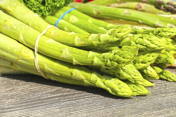 Green asparagus decorated on a rustic wooden table