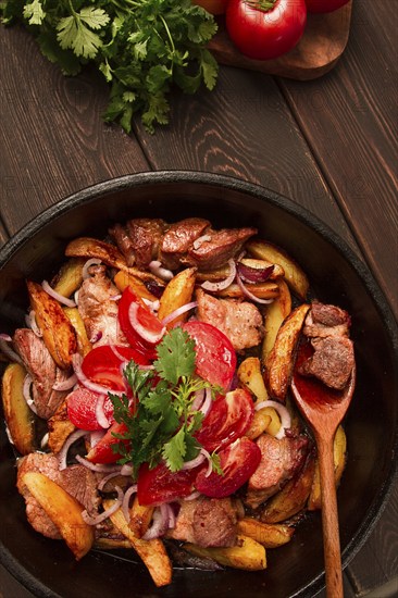 Ojakhuri, Traditional Georgian dish, fried potatoes with meat, in a clay frying pan, top view, no