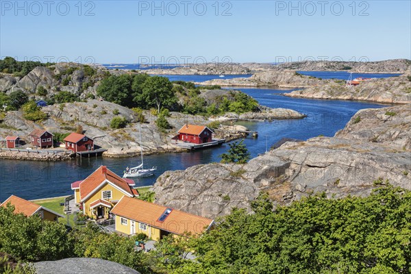 View of a rocky archipelago with boats and houses on the Swedish west coast on a beautiful summer