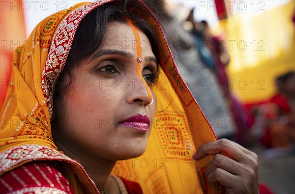 Hindu devotees perform rituals as they offer prayers to the Sun god in the bank of Brahmaputra