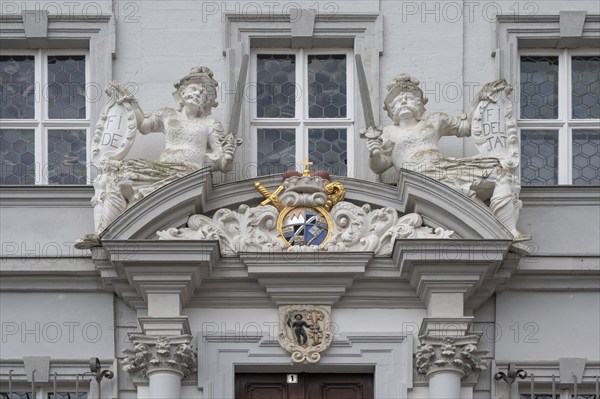 Entrance potal with sculptures and coat of arms of the baroque town hall, built in 1718, Iphofen,
