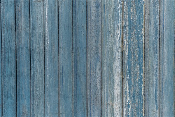 Garage door boards stained blue with worn paint. Brittany France