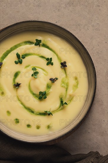 Mashed potatoes, with green butter and micro greenery, homemade, on a beige table, no people, top