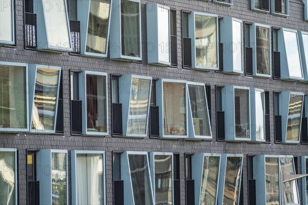Box-shaped windows, at different angles, façade of a residential building in Rotterdam, Netherlands