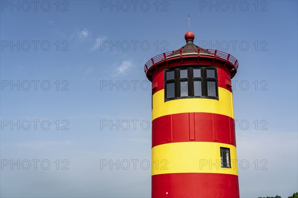 The Pilsum lighthouse on the North Sea dyke near Greetsiel, East Frisia, Lower Saxony, Germany,