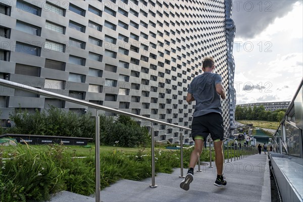 CopenHill, waste incineration plant and artificial ski slope, athletes use the stairs and paths for