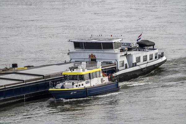 Water police boat sailing alongside a cargo ship on the Rhine near Duisburg, WSP 12, a police