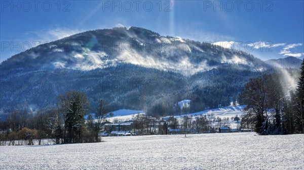 Snowy winter landscape with mountains in the background and sunny sky, Bad Feilnbach