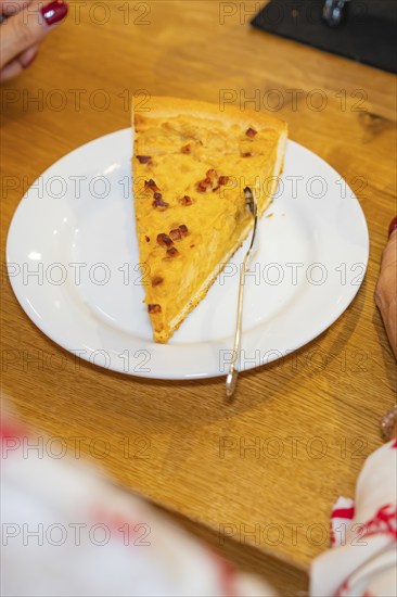 Piece of cake on a plate with a woman ready to eat it with a fork, autumn creations, Cafe Kuh,