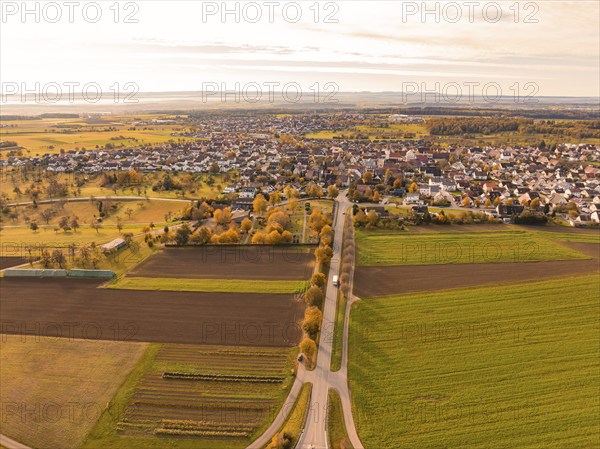View of a small town surrounded by extensive fields in autumn tones, Jettingen, Black Forest,