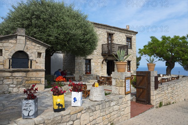 Traditional stone building with Mediterranean garden atmosphere and sea view, Afytos, Afitos,