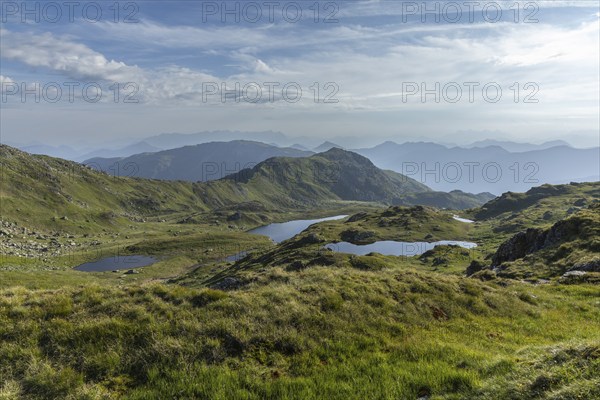 Vast mountain landscape with glittering mountain lakes under a blue sky, Neukirchen am