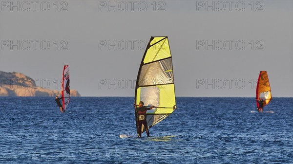 Windsurfer with coloured sail on the blue sea, windsurfer, Meltemi windsurfing spot, Devils Bay,