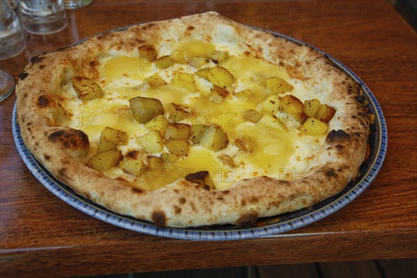 Italian cuisine, Mediterranean cuisine, pizza with potatoes and cheese, Taleggio, baked, from the