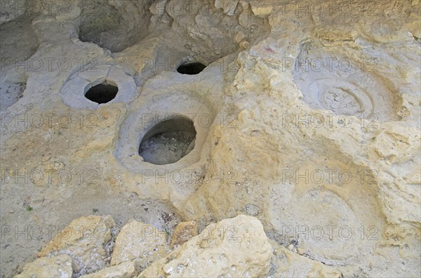 Prehistoric storage pits in limestone rock at the base of the Citadel, Rabat Victoria, Gozo, Malta,