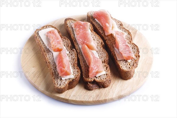 Smoked salmon sandwiches with butter on wooden board, isolated on white background. close up