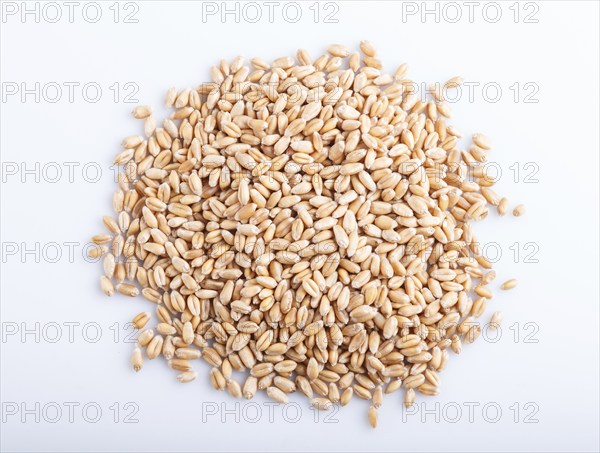 Heap of wheat grains isolated on white background. close up, top view
