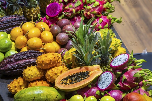 Exotic fruits, lychee, jackfruit, dragon fruit, mango and citrus fruits presented on a table,