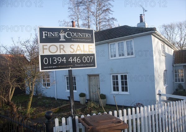 Fine and Country estate agent for sale sign outside detached rural house, Suffolk, England, United