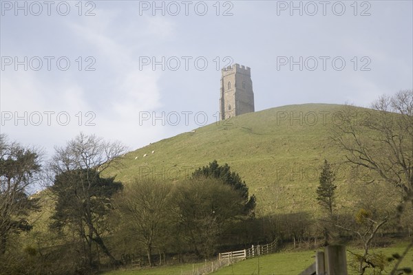 St Michael's Tower on Glastonbury Tor, Somerset, England in misty haze with blue sky