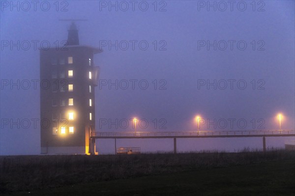 Thick fog in winter, hanging over the mouth of the Elbe into the North Sea, radar tower of the