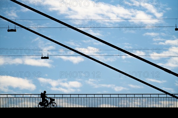 Cyclist, on the Rheinknie Bridge in Düsseldorf, North Rhine-Westphalia, Germany, Europe