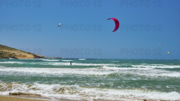 Kitesurfer glides with his kite over the waves of the sea, surfers paradise, kitesurfer,
