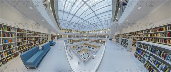 Galeriesaaal, Modern library with glass roof and white stairs, surrounded by bookshelves in a
