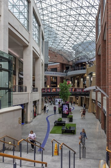 Bright interior of a modern shopping centre with glass ceiling, Belfast