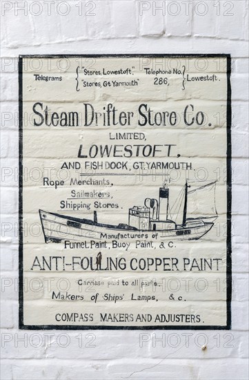 Old fashioned sign on wall for Steam Drifter Store Co Ltd, Kirkley, Lowestoft, Suffolk, England, UK
