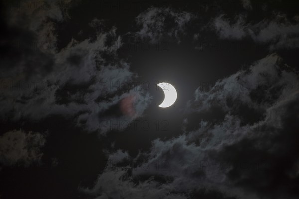 Partial solar eclipse with light cloud cover on 2 October 2024 in Buenos Aires, Argentina, South