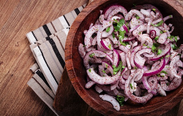 Chopped red onion, with sumac and herbs, in a bowl, pickled Spanish onion, close-up, top view