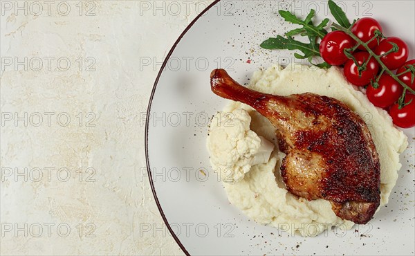 Fried duck shank, cauliflower puree, cherry tomatoes, homemade, no people