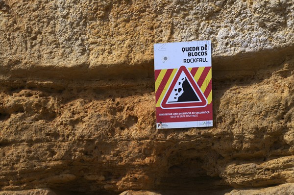 Rockfall, warning sign, danger of falling rocks, unstable cliff, beach, Praia da Dona Ana, Lagos,