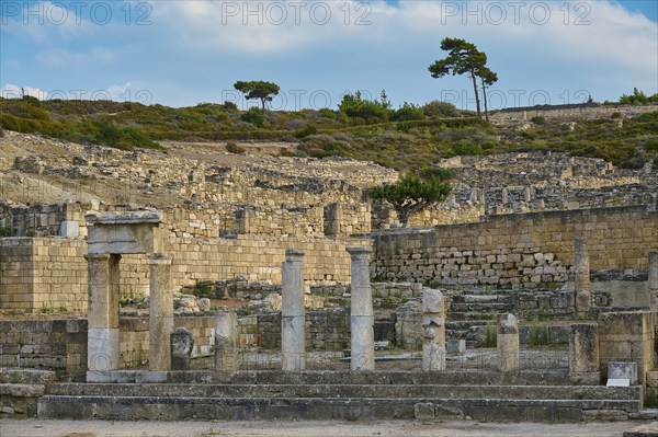 Ancient temple with half-ruined columns and stone structures in a natural setting, Well house,