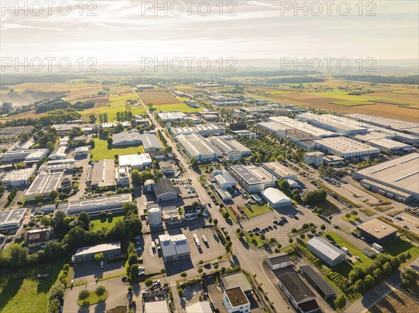 A bird's eye view of an industrial area with numerous factory buildings and neighbouring fields
