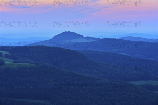 A calming mountain landscape at dusk with soft blue tones and a romantic horizon, Milseburg,