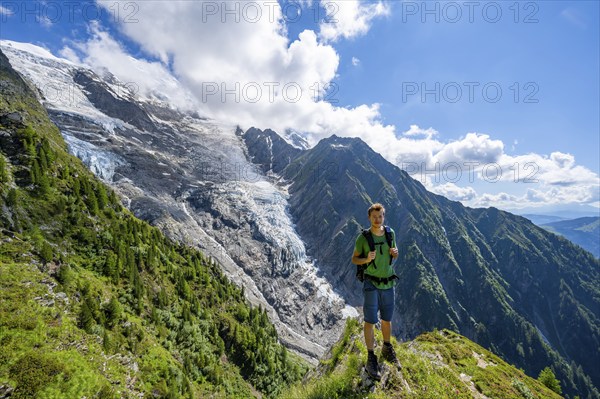 Mountaineer in front of impressive mountain landscape with glacier, view of glacier Glacier de