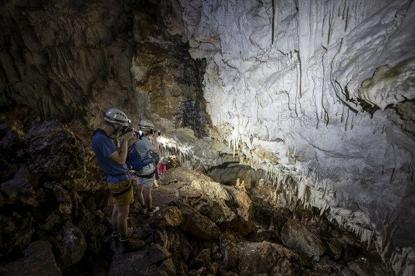 Tourists in a stalactite cave, Terciopelo Cave, Barra Honda National Park, Costa Rica, Central