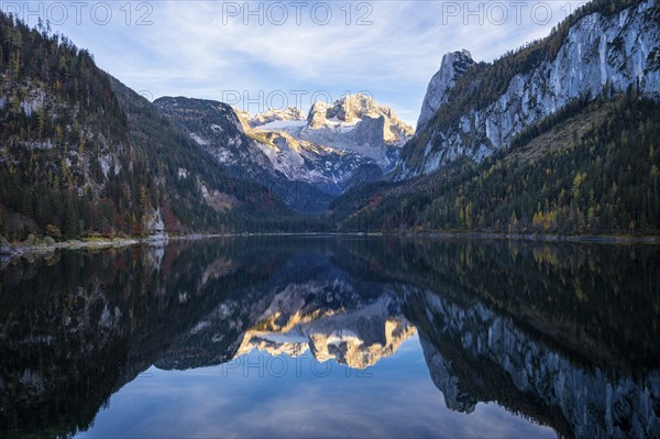 The Vordere Gosausee lake in autumn with a view of the Dachstein mountain range. The Gosaukamm on
