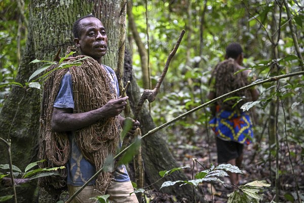 Pygmy of the Baka or BaAka people with his hunting net, Dzanga-Sangha Special Dense Forest Reserve,