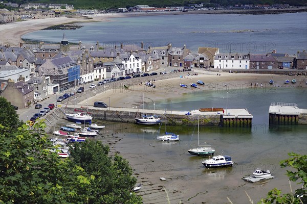Coastal village with beach, boats and houses surrounded by hills, Stonehaven, Aberdeenshire,