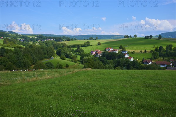 Green hills with scattered rural houses under a clear blue sky, Wachtküppel, Gersfeld, Rhön, Hesse,