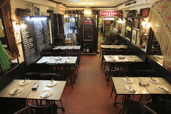 Restaurant dining tables inside famous historic Los Gatos Cervecerias bar, Madrid, Spain, Europe