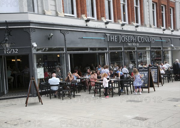 People sitting outside The Joseph Conrad Wetherspoons pub, Lowestoft, Suffolk, England, United