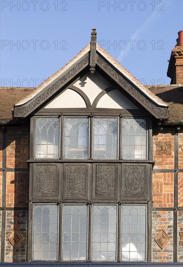 Facade of historic 1925 building heraldic symbols and signs, 105 High Street, Marlborough,