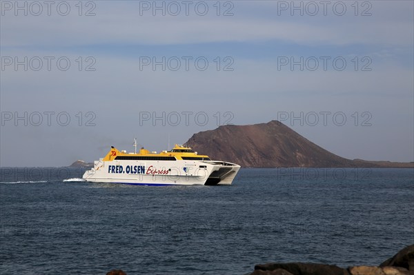 Fred Olsen Express ferry ship passing Los Lobos island, Corralejo, Fuerteventura, Canary Islands,
